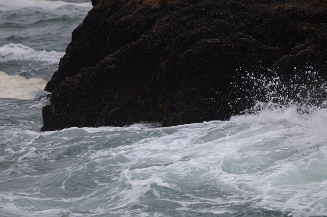 Furious Waves Crash Against Dark Coastal Rock
