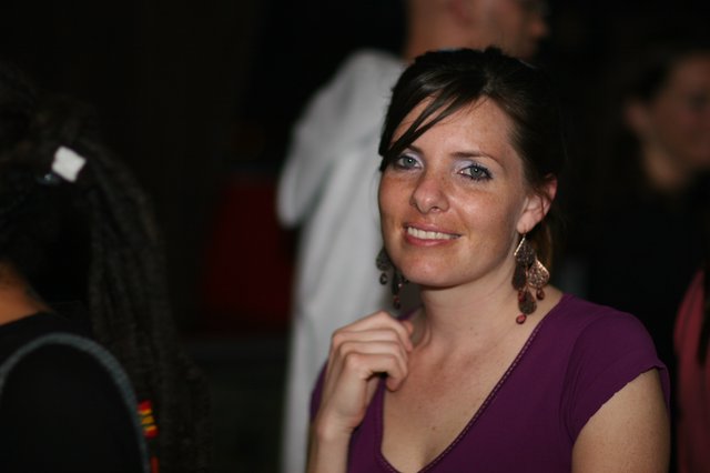 Smiling Woman in Purple at Evening Social Event