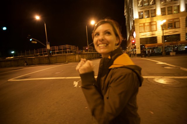 Joyful Woman Celebrating on City Streets at Night