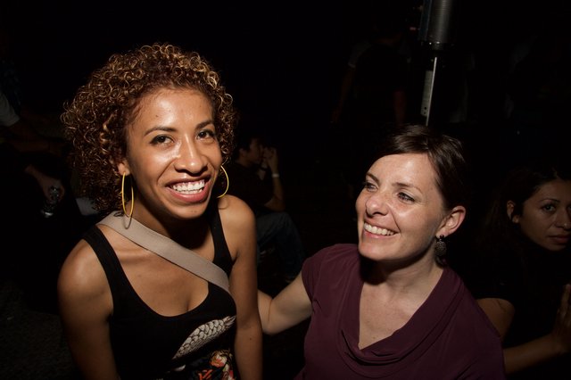 Two Women Smiling Together at Nightclub Event