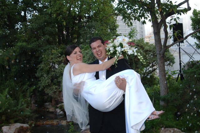Joyful Groom Carries Laughing Bride on Wedding Day