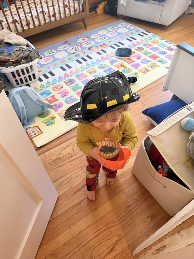 Young Child Playing Firefighter at Home