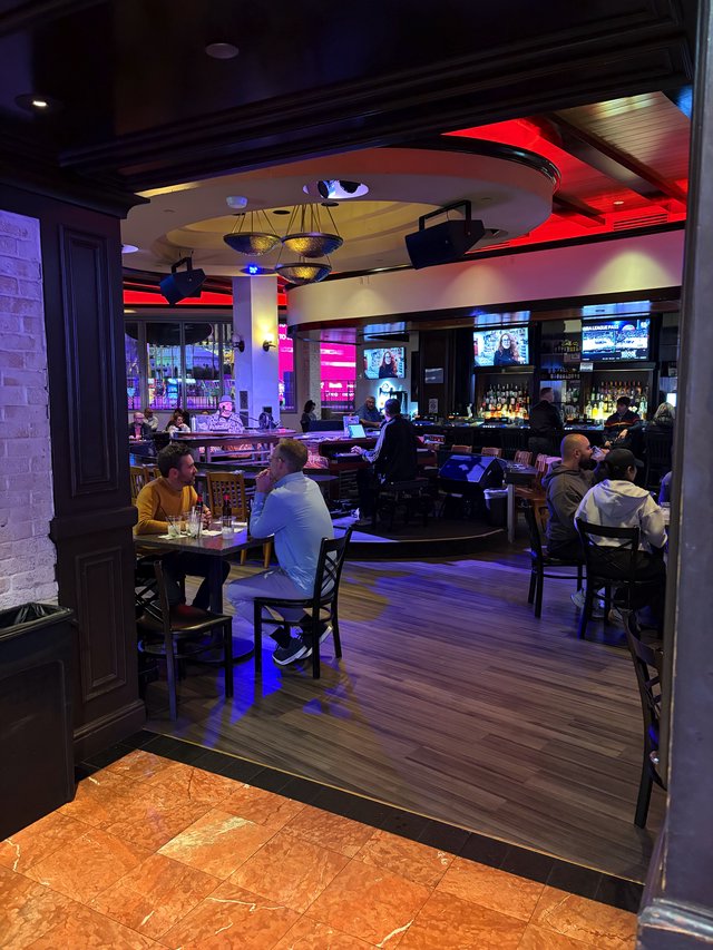 Modern Sports Bar Interior with Vibrant Red Accent Lighting