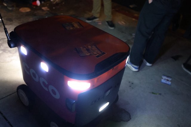 Coco Delivery Robot Navigates Nighttime Festival Crowd
