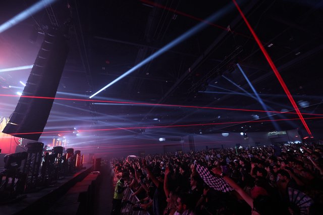 Laser Light Storm Over Pulsing Festival Crowd