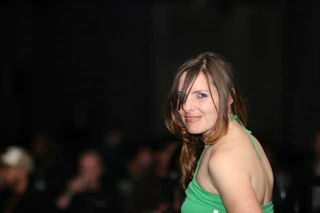 Woman in Green Halter Glances Back at Camera