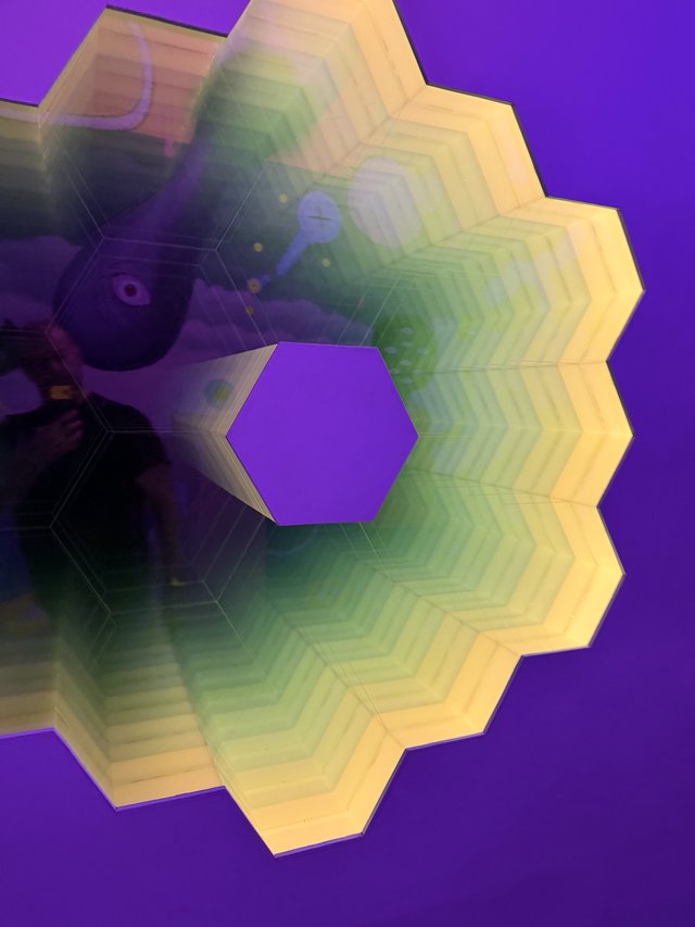 Rainbow Hexagonal Light Installation Against Purple Wall