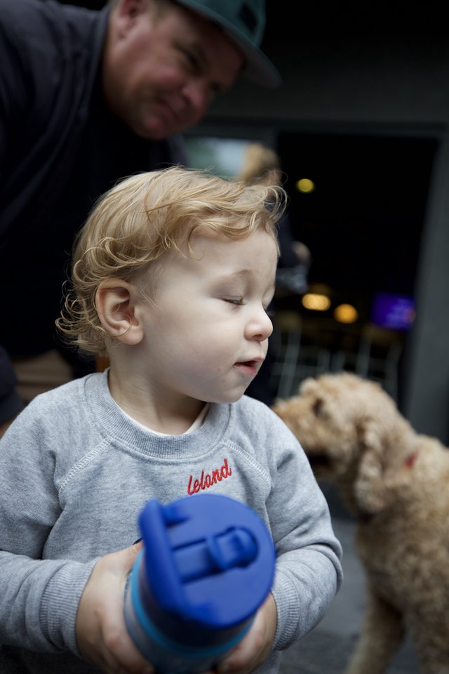 Toddler with Curly Hair Playing with Blue Toy