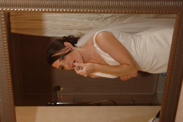 Bride Applies Lipstick in Ornate Bathroom Mirror