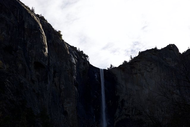Dramatic Waterfall Between Towering Granite Cliffs at Dusk