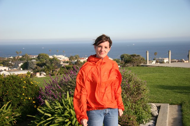 Woman in Orange Jacket Overlooking California Coastal Town