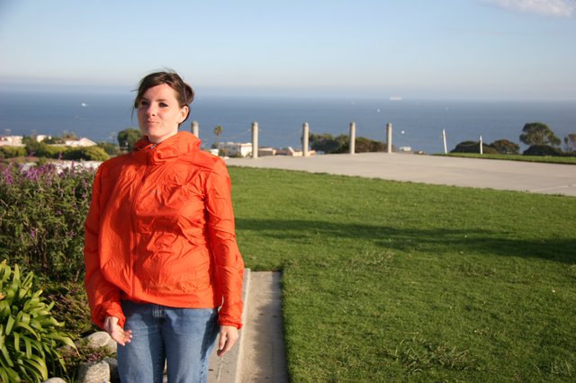 Woman in Orange Jacket by the California Coast