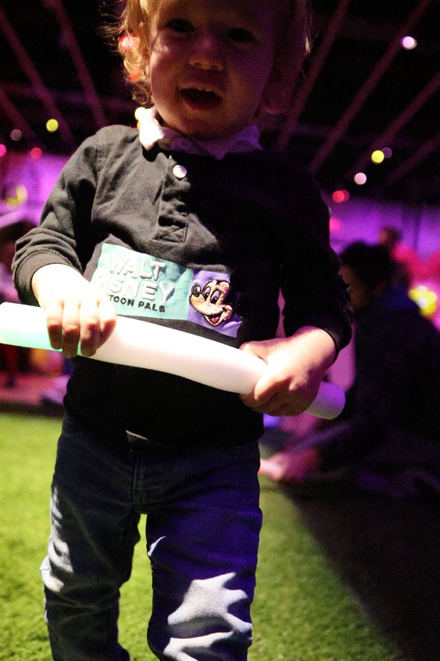Toddler with Glow Sticks at Baby Rave Event
