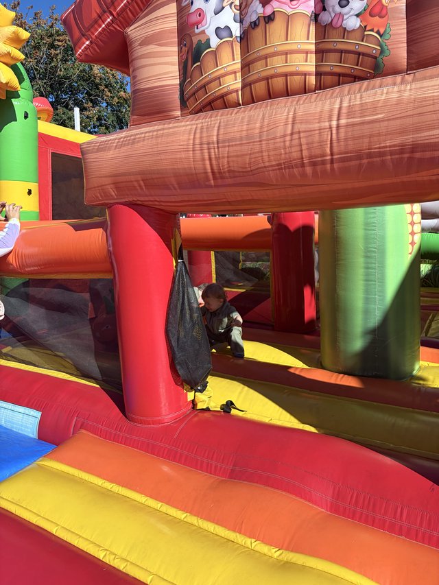 Child Playing on Colorful Inflatable Bounce House