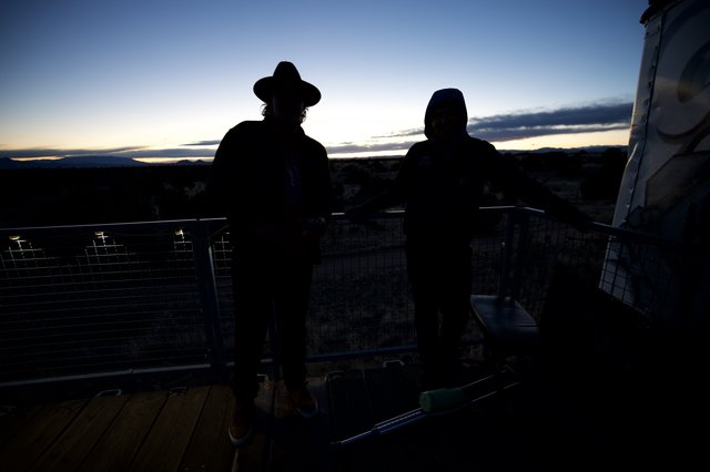 Twilight Contemplation: Silhouettes Against Desert Sunset