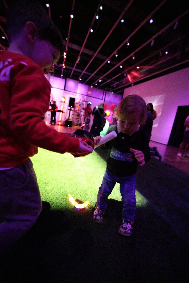 Child Dancing with Adult at Baby Rave Event