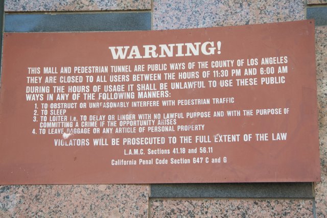 Warning Plaque on Building Wall