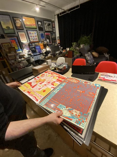 Man showcasing artwork on living room table