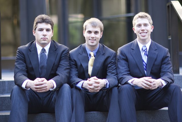 Three Men in Suits Sitting on Steps