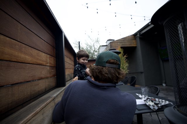Father and Son Moment in Backyard Patio