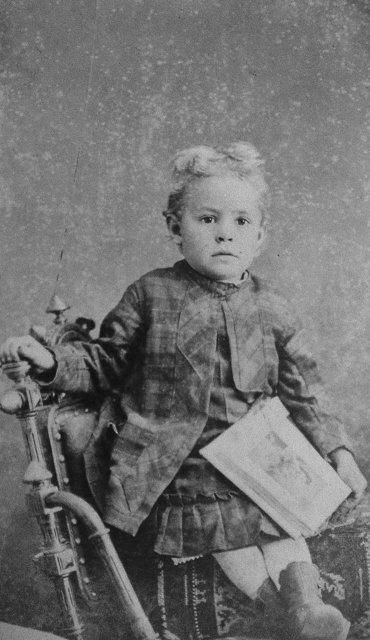 Vintage Portrait of Young Boy Sitting on Chair