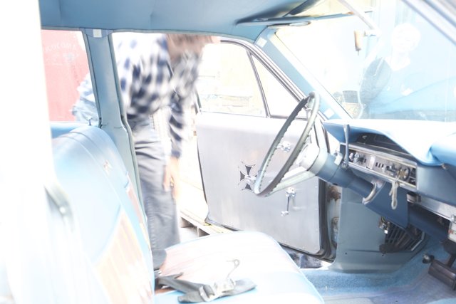 Man inspecting the interior of a car