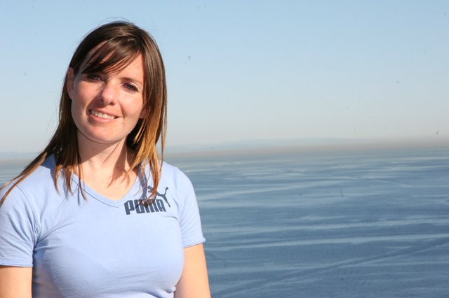 Smiling Woman by the Sea at Golden Hour