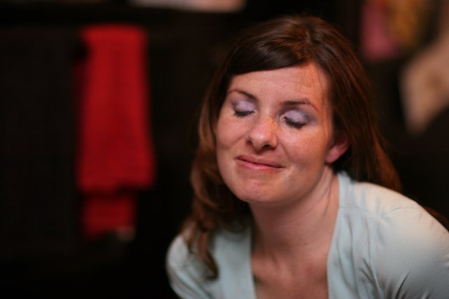 Contemplative Woman with Eyes Closed in Low Light