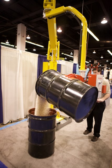 Man Standing Next to a Barrel at the 2008 Robot Automation Show