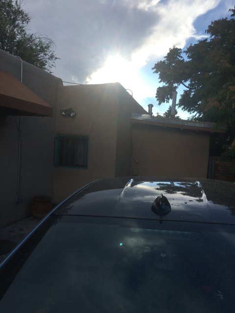 Parked Sports Car in Front of Santa Fe House Under the Sun