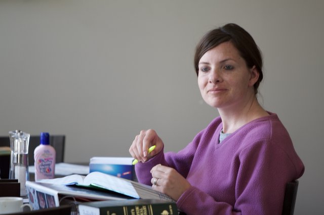 Woman Studying with Highlighter at Desk