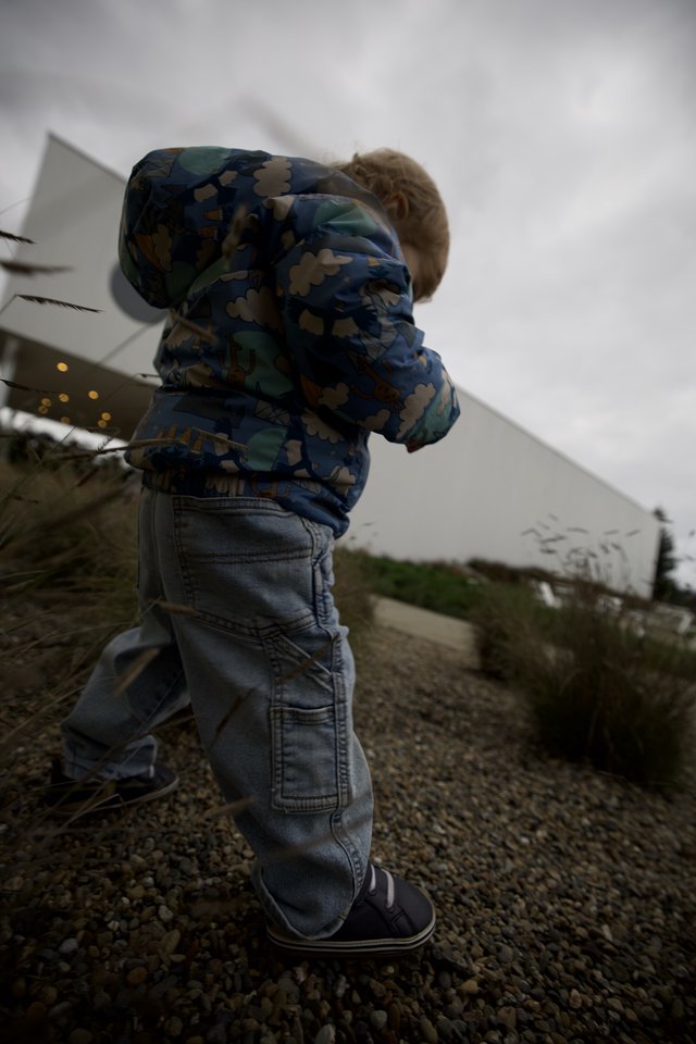 Young Child Running on Gravel Path at Dusk