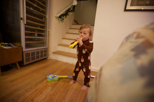 Toddler Playing Yellow Recorder on Christmas Morning