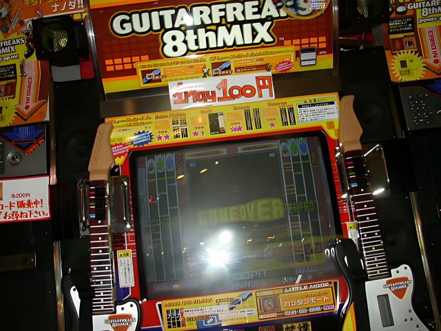 Jamming to the Beat: Guitar Freaks 8 Arcade Game Machine