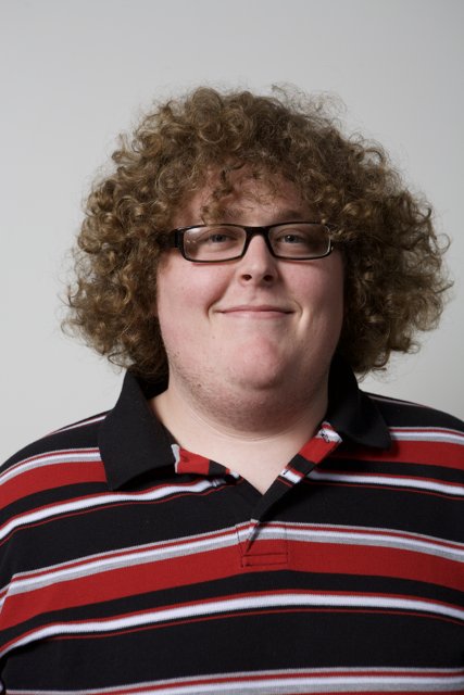 Happy Man with Curly Hair and Glasses