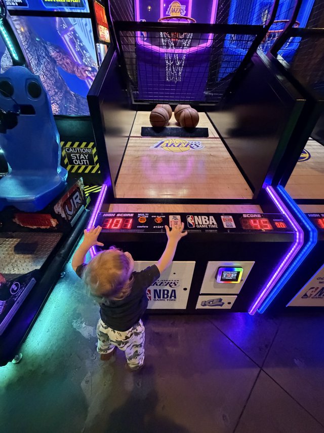 Young Child Playing NBA Arcade Basketball Game