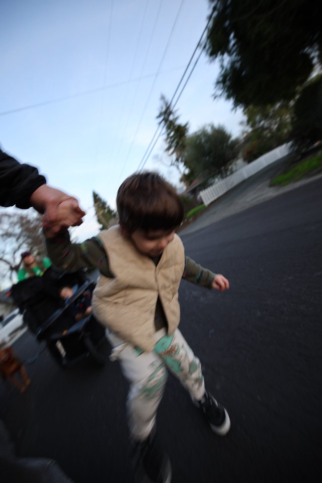 Child Running on Suburban Street at Dusk