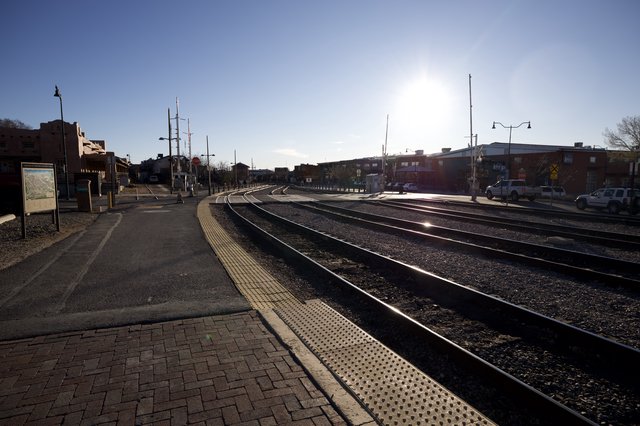 Sunlit Railroad Tracks Curve Through Santa Fe Station