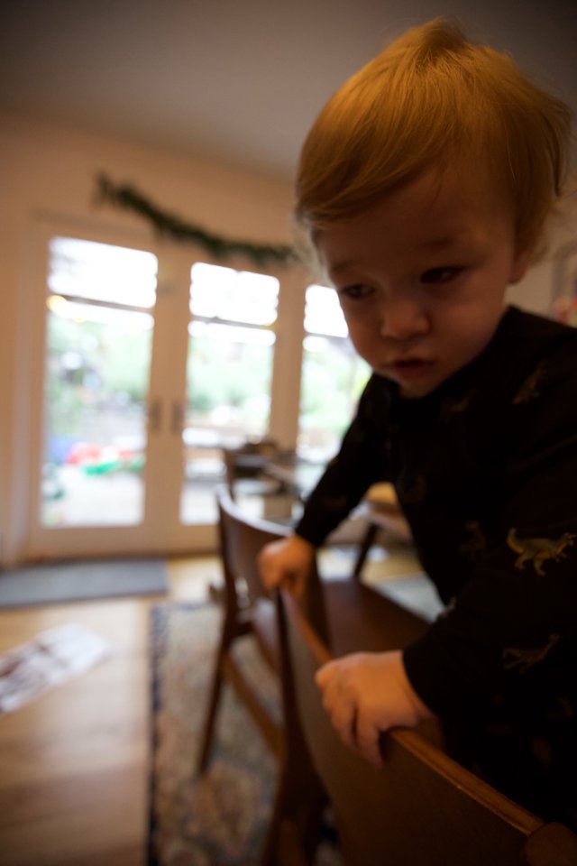 Curious Toddler with Red Hair Exploring at Home