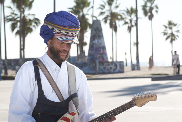 Turbaned musician with an acoustic guitar