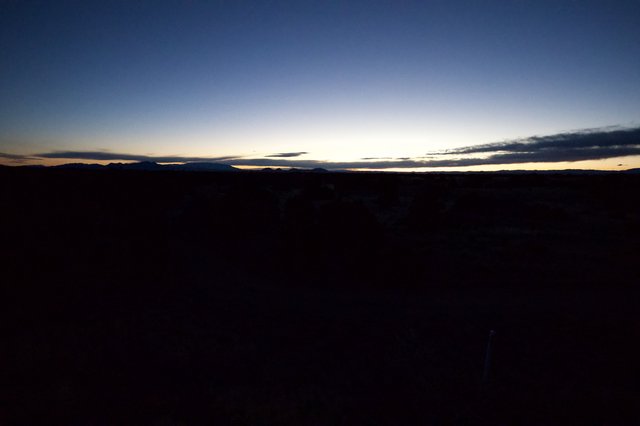 Desert Twilight Over Distant Mountain Silhouettes