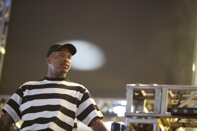 YG takes the stage in bold stripes and a cap
