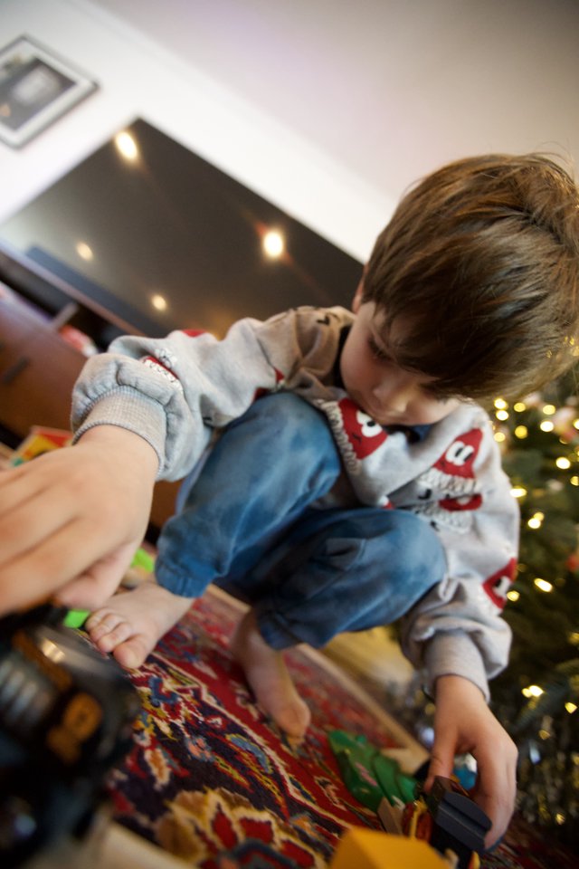 Child Opening Christmas Presents on Holiday Morning