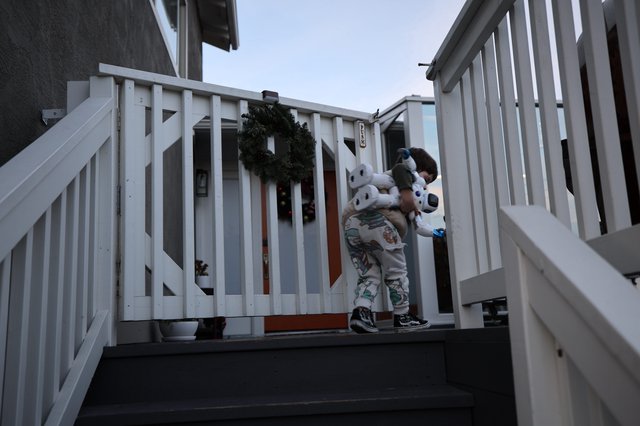 Child with Stuffed Animal on Winter Porch at Dusk