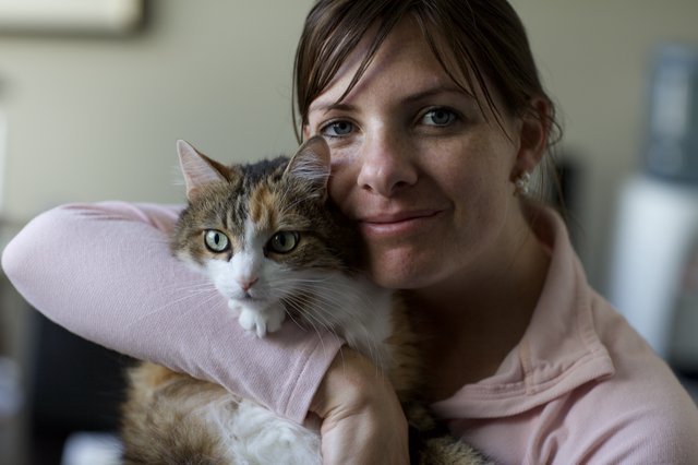 Woman and Her Calico Cat Share a Tender Moment