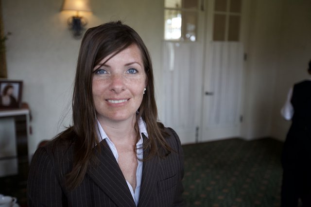 Professional Woman Smiling at a Funeral Reception