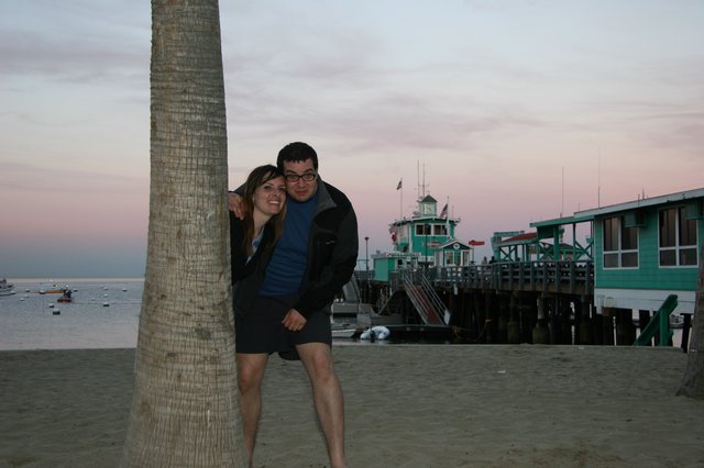 Couple Poses by Palm Tree at Sunset Pier