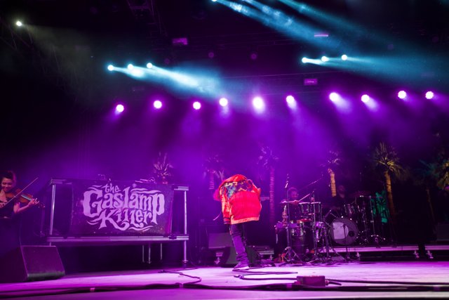 Red-Shirted Rockstar in Purple Lights