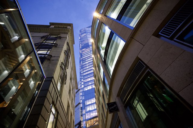 Modern Skyscraper Rising Between Historic London Buildings at Dusk