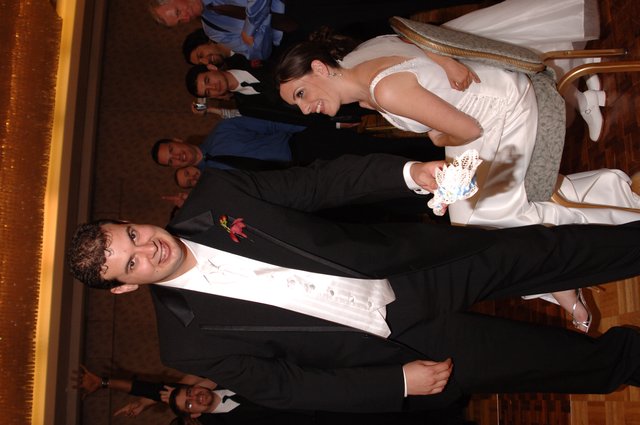 Groom Removes Garter at Joyful Wedding Reception